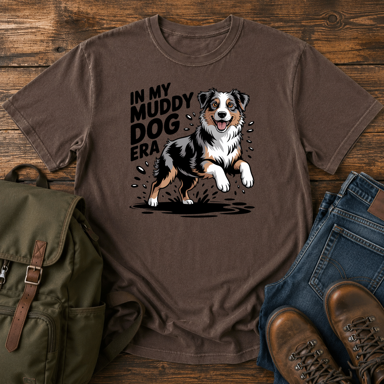 Australian Shepherd dog shaking off muddy creek water on a retro outdoor t-shirt design.