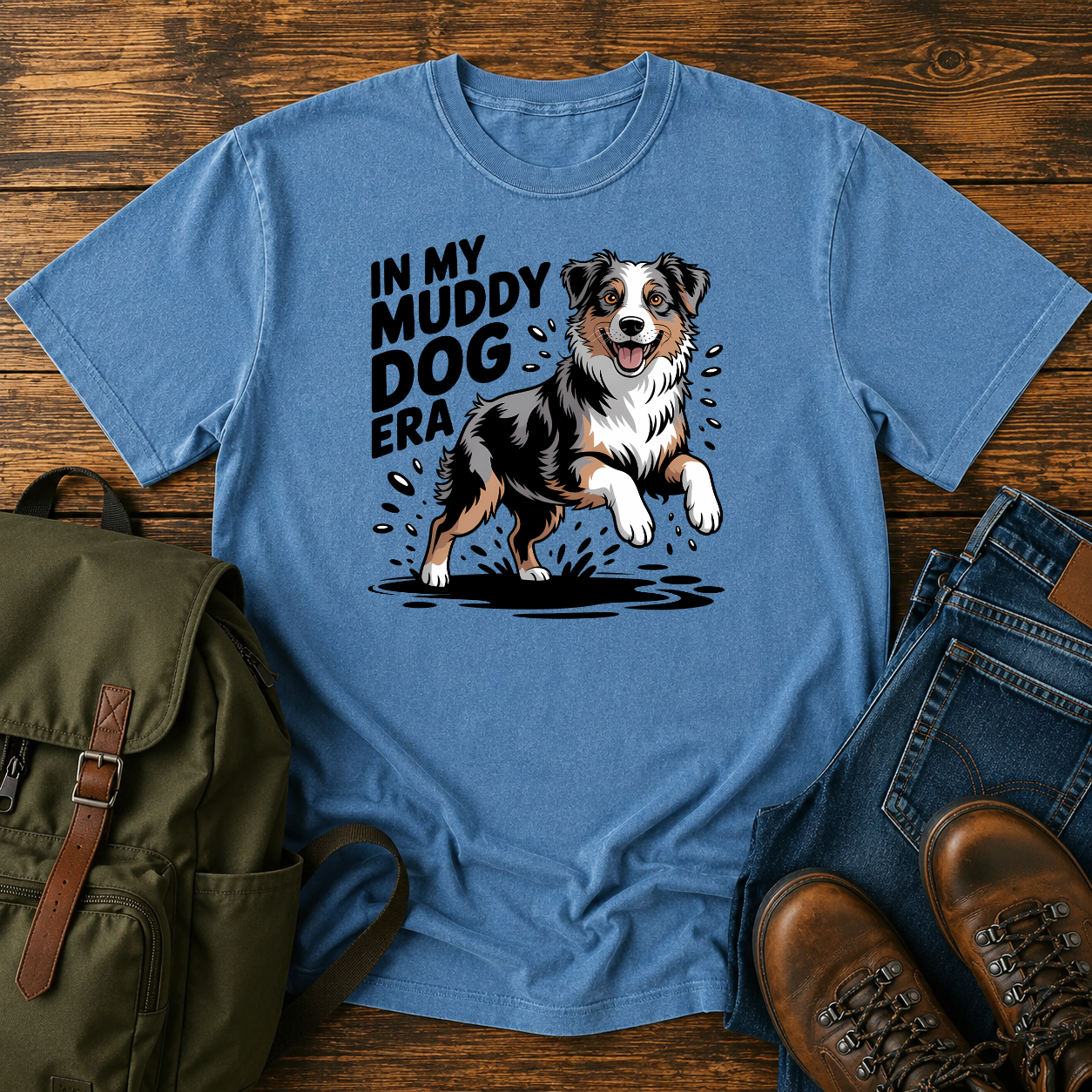 Australian Shepherd dog shaking off muddy creek water on a retro outdoor t-shirt design.