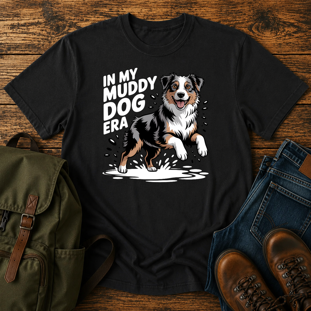 Australian Shepherd dog shaking off muddy creek water on a retro outdoor t-shirt design.