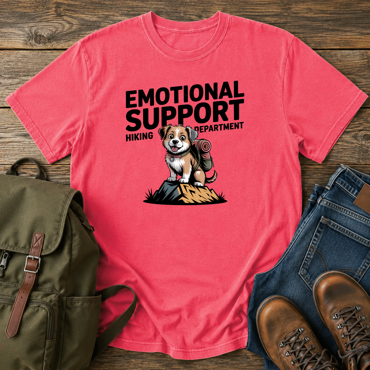 Scruffy rescue mutt riding in a backpack at a summit marker on a funny hiking t-shirt design.