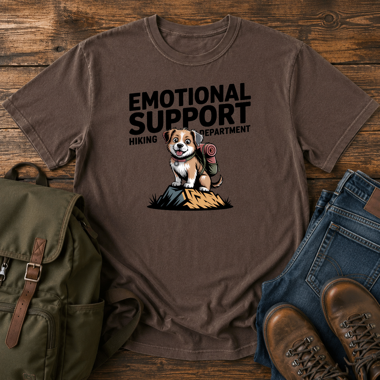 Scruffy rescue mutt riding in a backpack at a summit marker on a funny hiking t-shirt design.