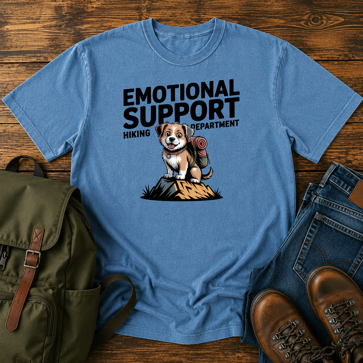 Scruffy rescue mutt riding in a backpack at a summit marker on a funny hiking t-shirt design.