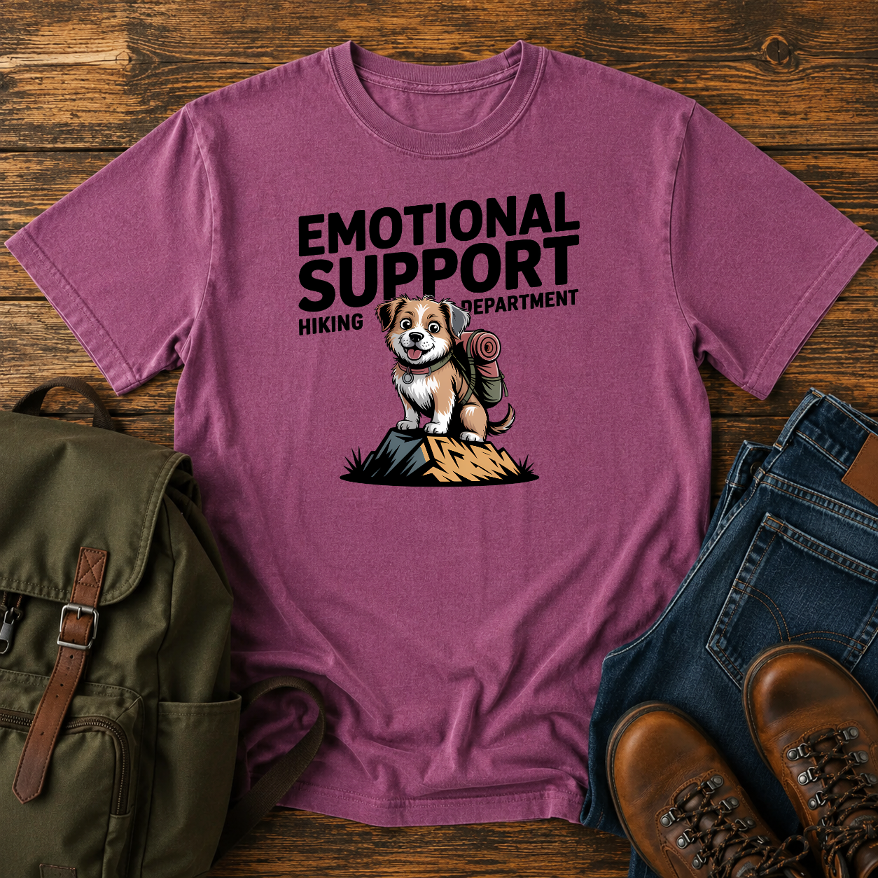 Scruffy rescue mutt riding in a backpack at a summit marker on a funny hiking t-shirt design.