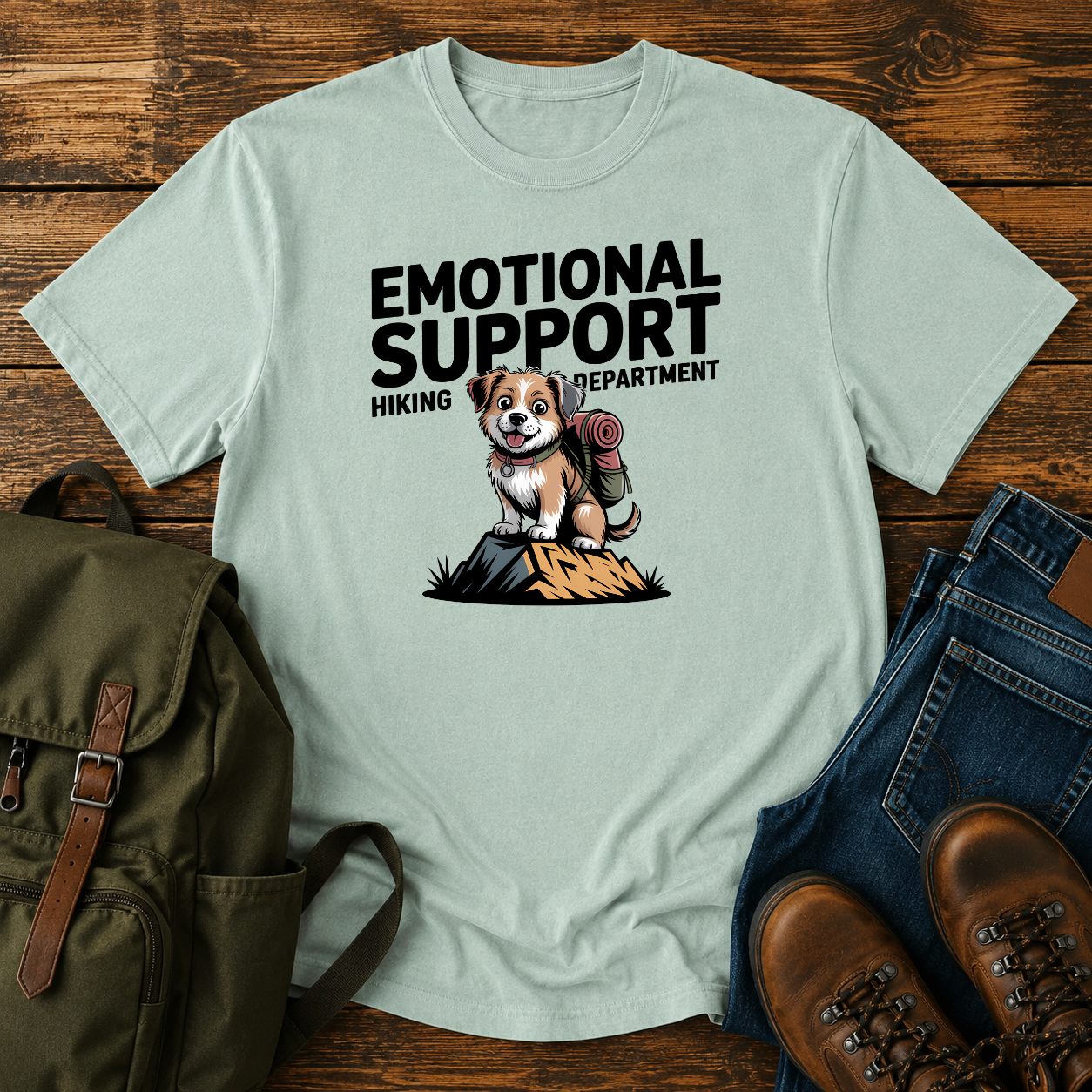 Scruffy rescue mutt riding in a backpack at a summit marker on a funny hiking t-shirt design.