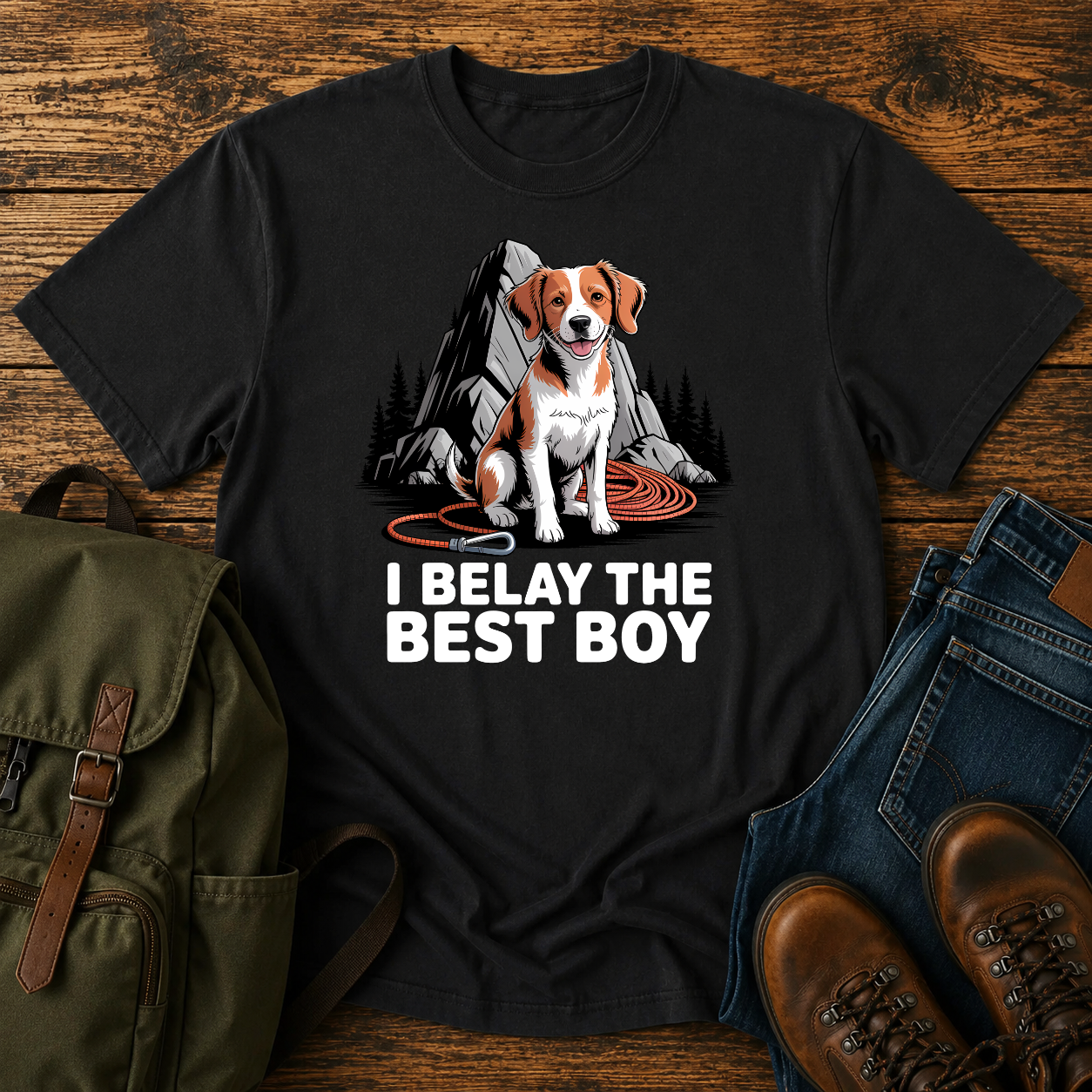 Brittany spaniel at granite boulder base with coiled climbing rope and carabiner on t-shirt