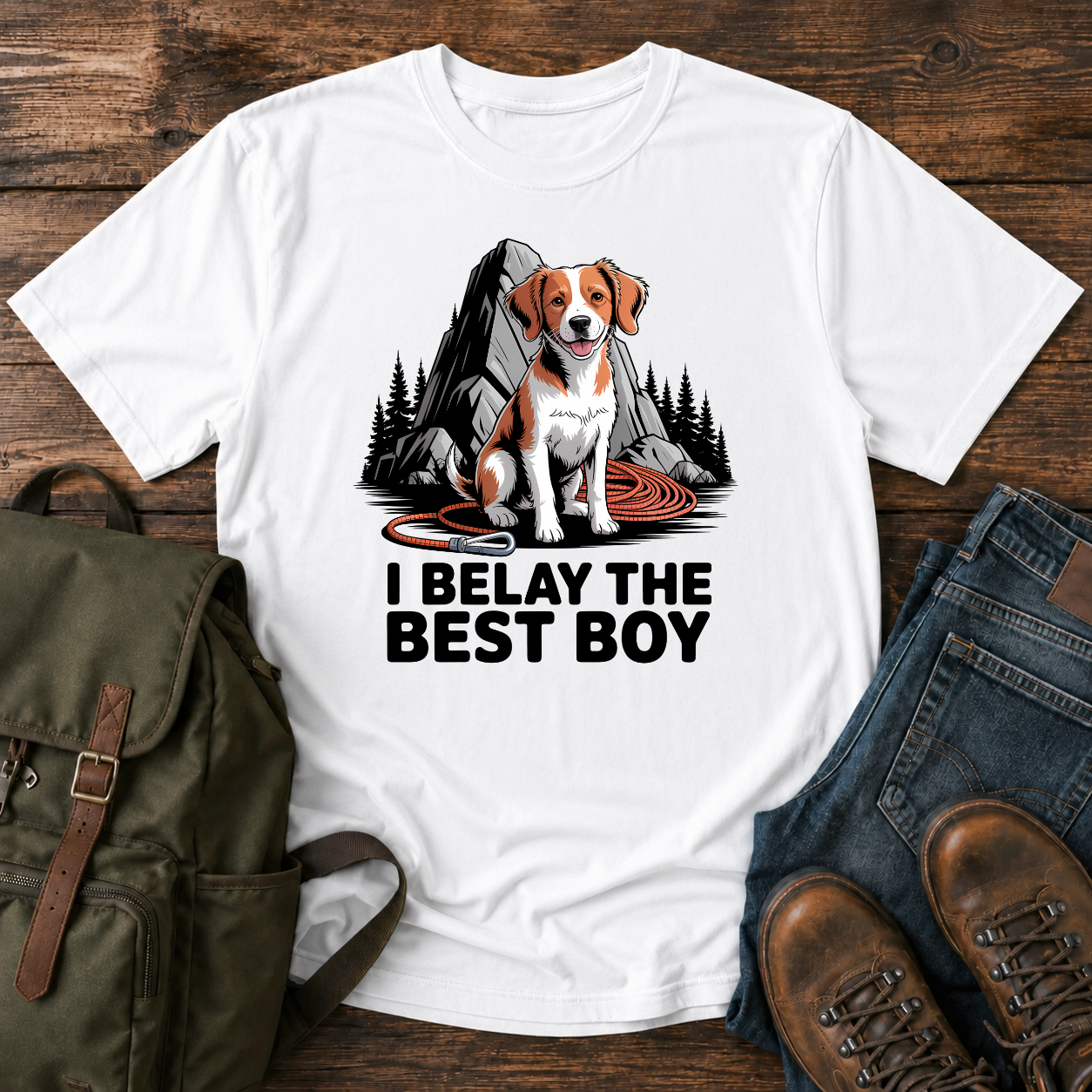 Brittany spaniel at granite boulder base with coiled climbing rope and carabiner on t-shirt