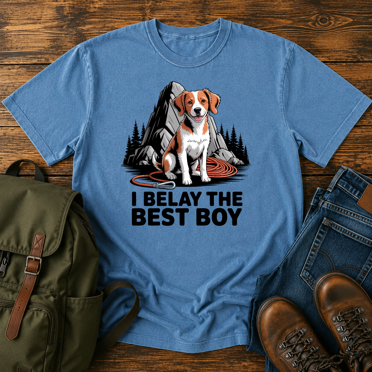 Brittany spaniel at granite boulder base with coiled climbing rope and carabiner on t-shirt