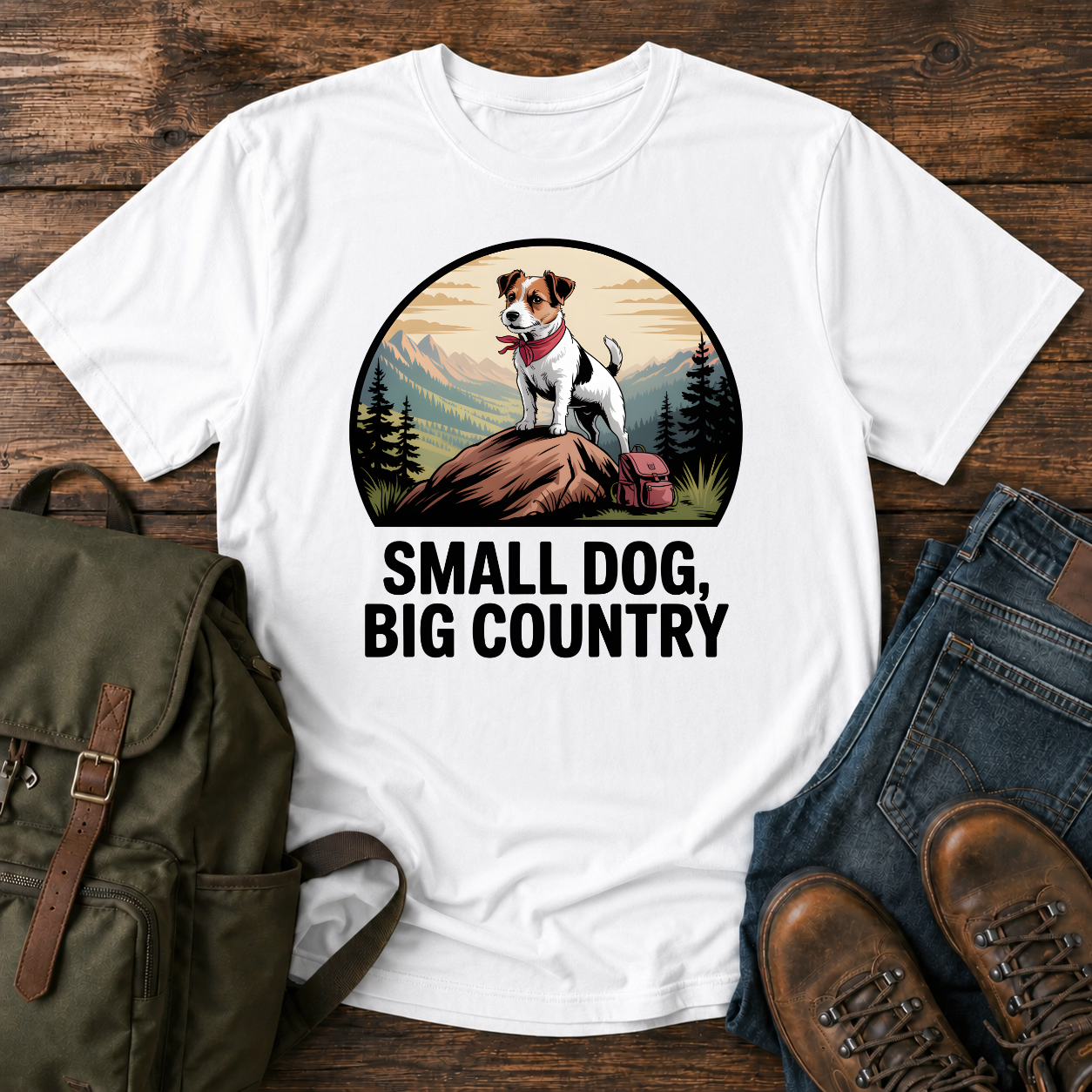 Jack Russell Terrier standing atop a mountain boulder with bandana flapping in the wind on a vintage trail t-shirt.