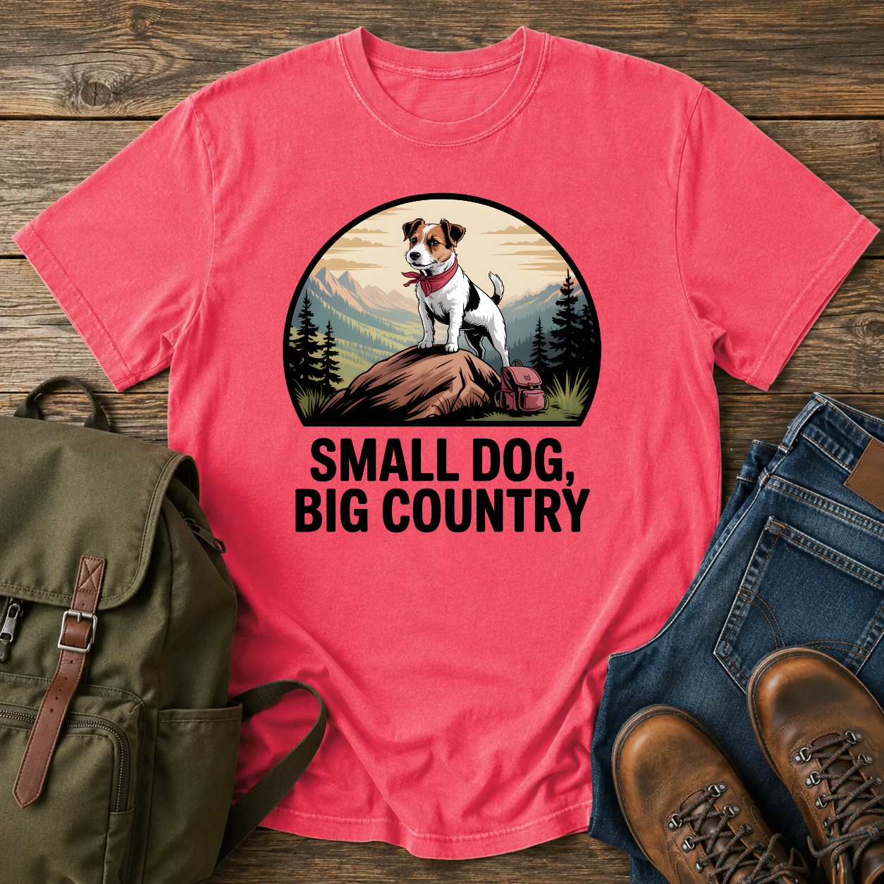 Jack Russell Terrier standing atop a mountain boulder with bandana flapping in the wind on a vintage trail t-shirt.
