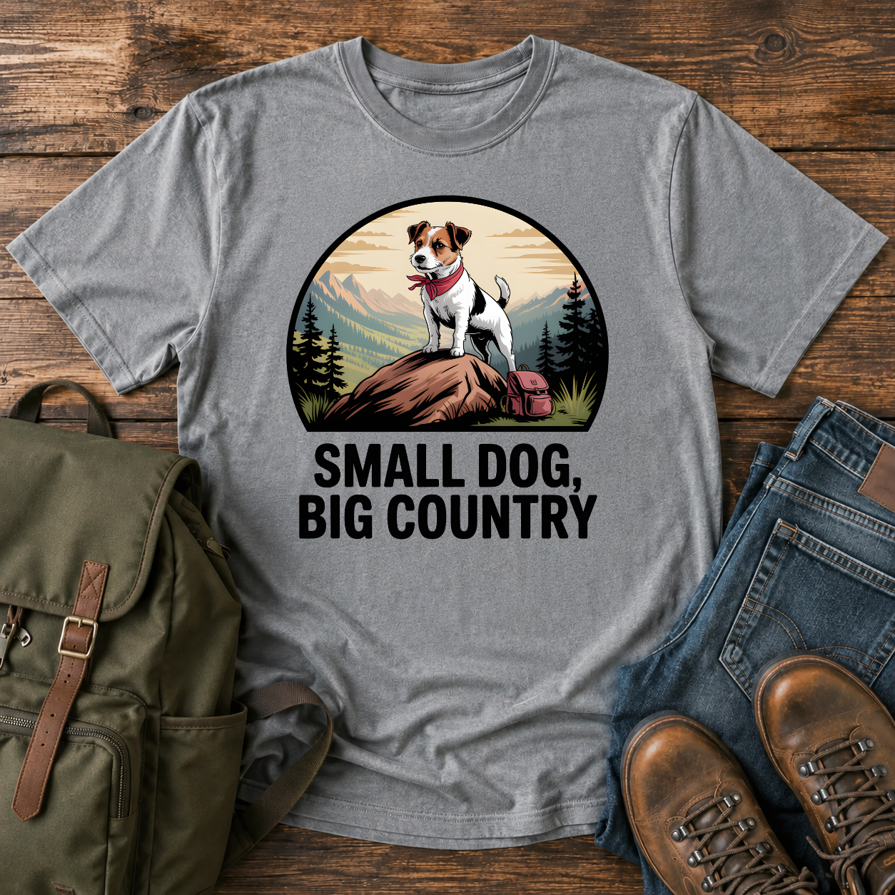 Jack Russell Terrier standing atop a mountain boulder with bandana flapping in the wind on a vintage trail t-shirt.
