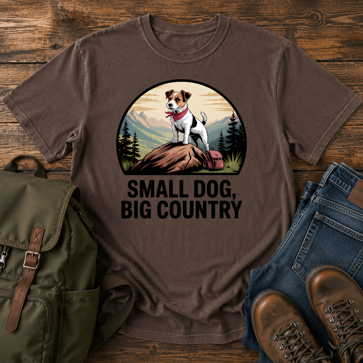 Jack Russell Terrier standing atop a mountain boulder with bandana flapping in the wind on a vintage trail t-shirt.