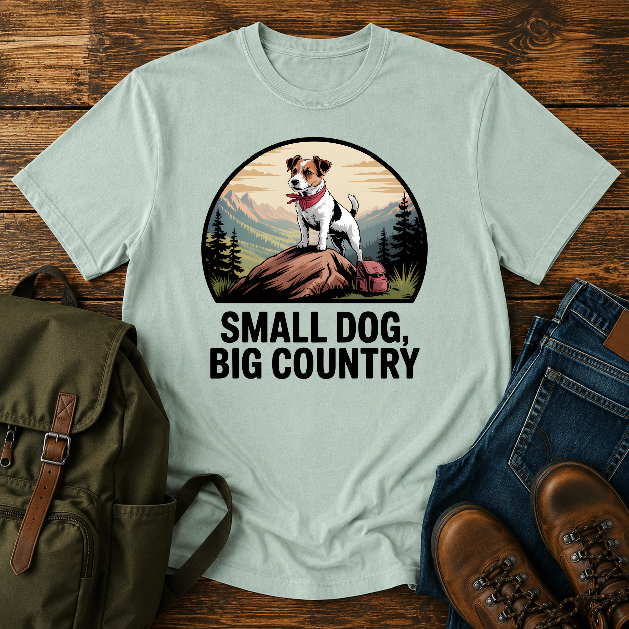 Jack Russell Terrier standing atop a mountain boulder with bandana flapping in the wind on a vintage trail t-shirt.