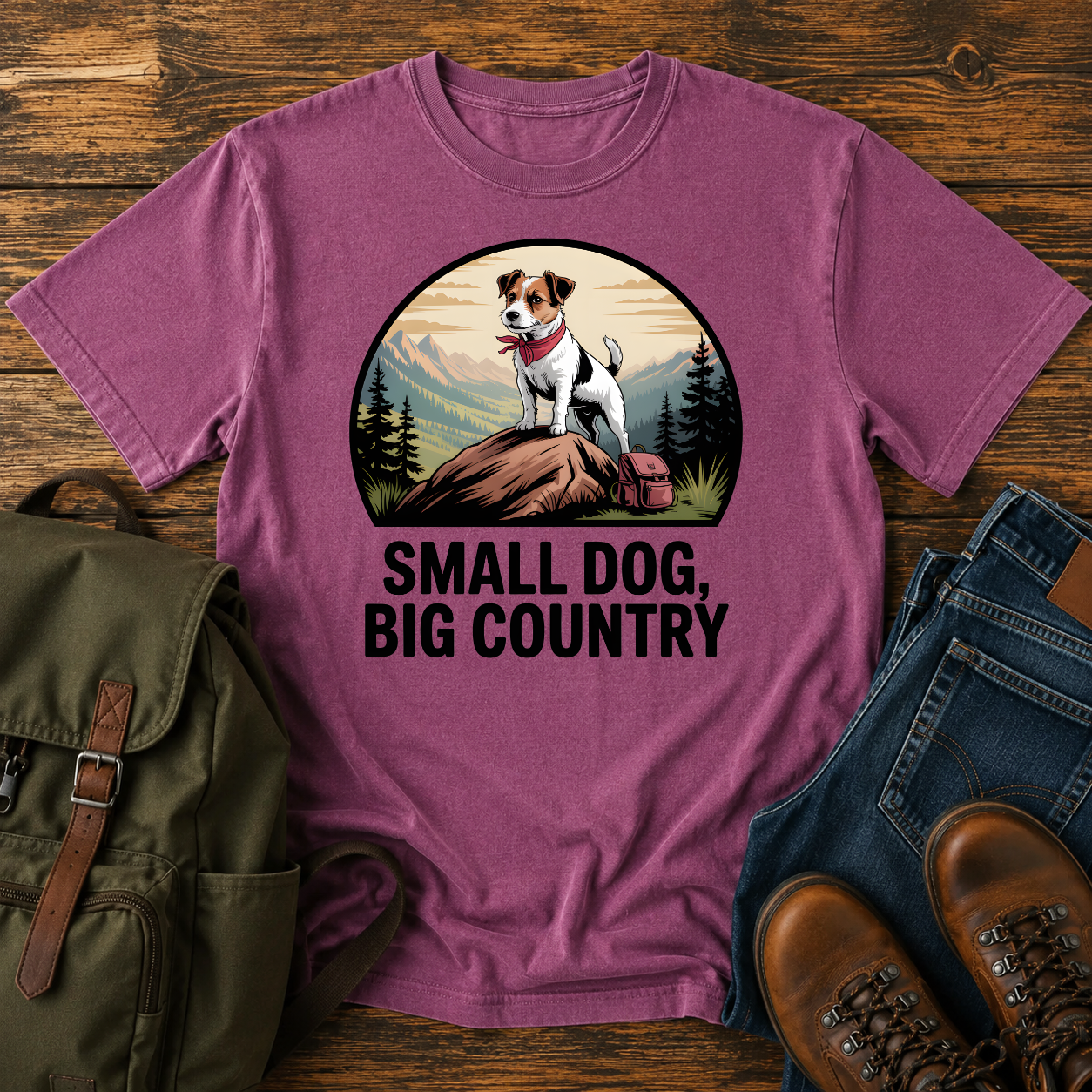 Jack Russell Terrier standing atop a mountain boulder with bandana flapping in the wind on a vintage trail t-shirt.