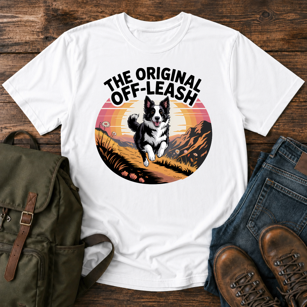Border Collie running free along a mountain ridgeline at golden hour on a vintage-style adventure t-shirt.