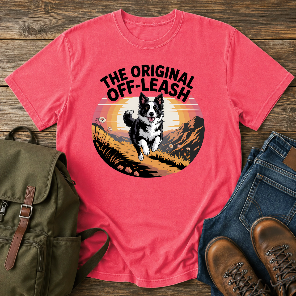 Border Collie running free along a mountain ridgeline at golden hour on a vintage-style adventure t-shirt.