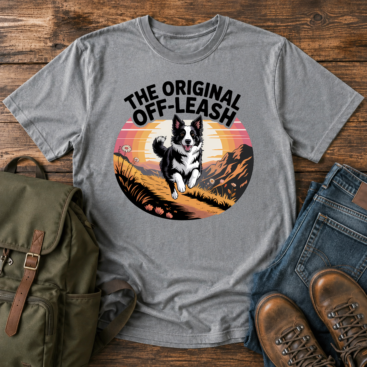 Border Collie running free along a mountain ridgeline at golden hour on a vintage-style adventure t-shirt.