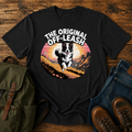 Border Collie running free along a mountain ridgeline at golden hour on a vintage-style adventure t-shirt.
