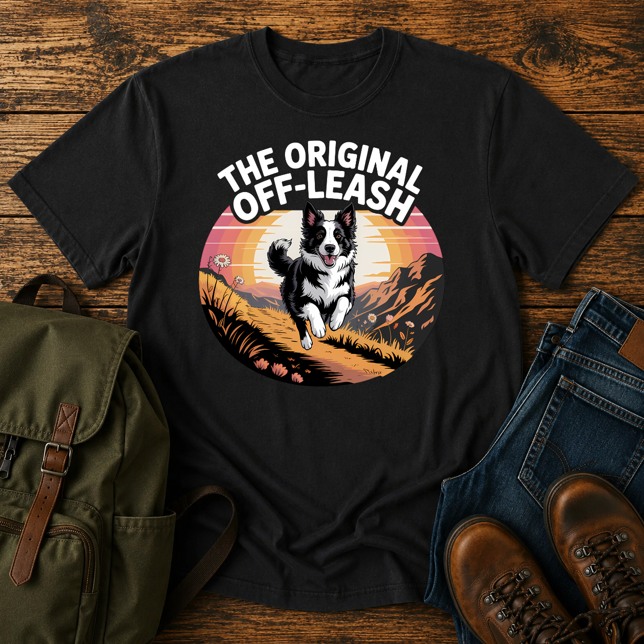 Border Collie running free along a mountain ridgeline at golden hour on a vintage-style adventure t-shirt.
