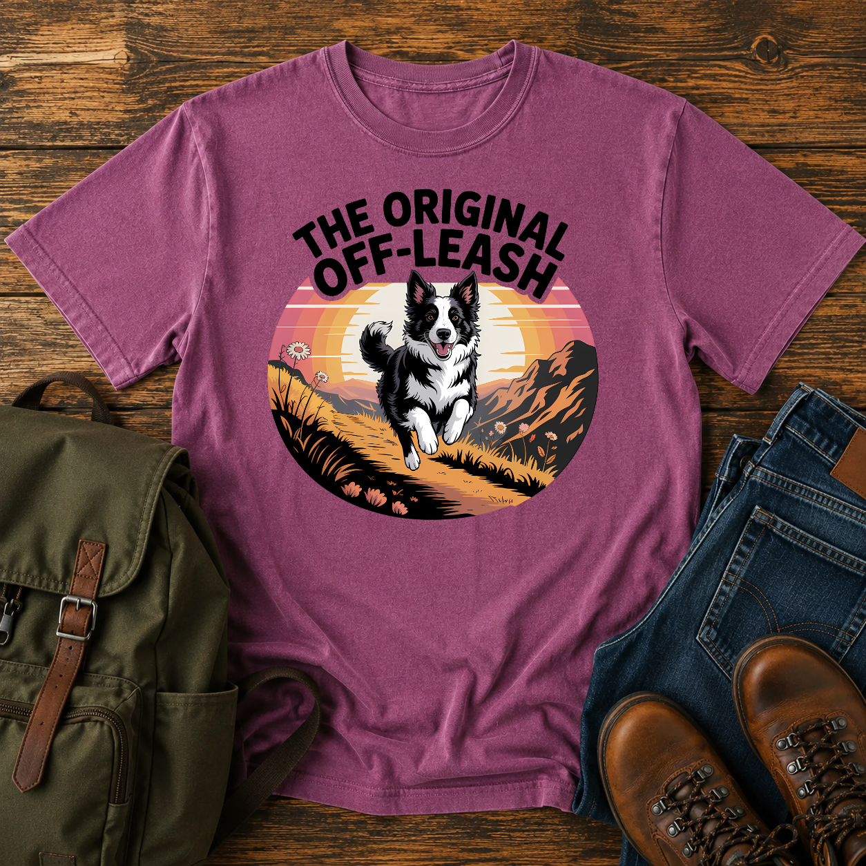 Border Collie running free along a mountain ridgeline at golden hour on a vintage-style adventure t-shirt.