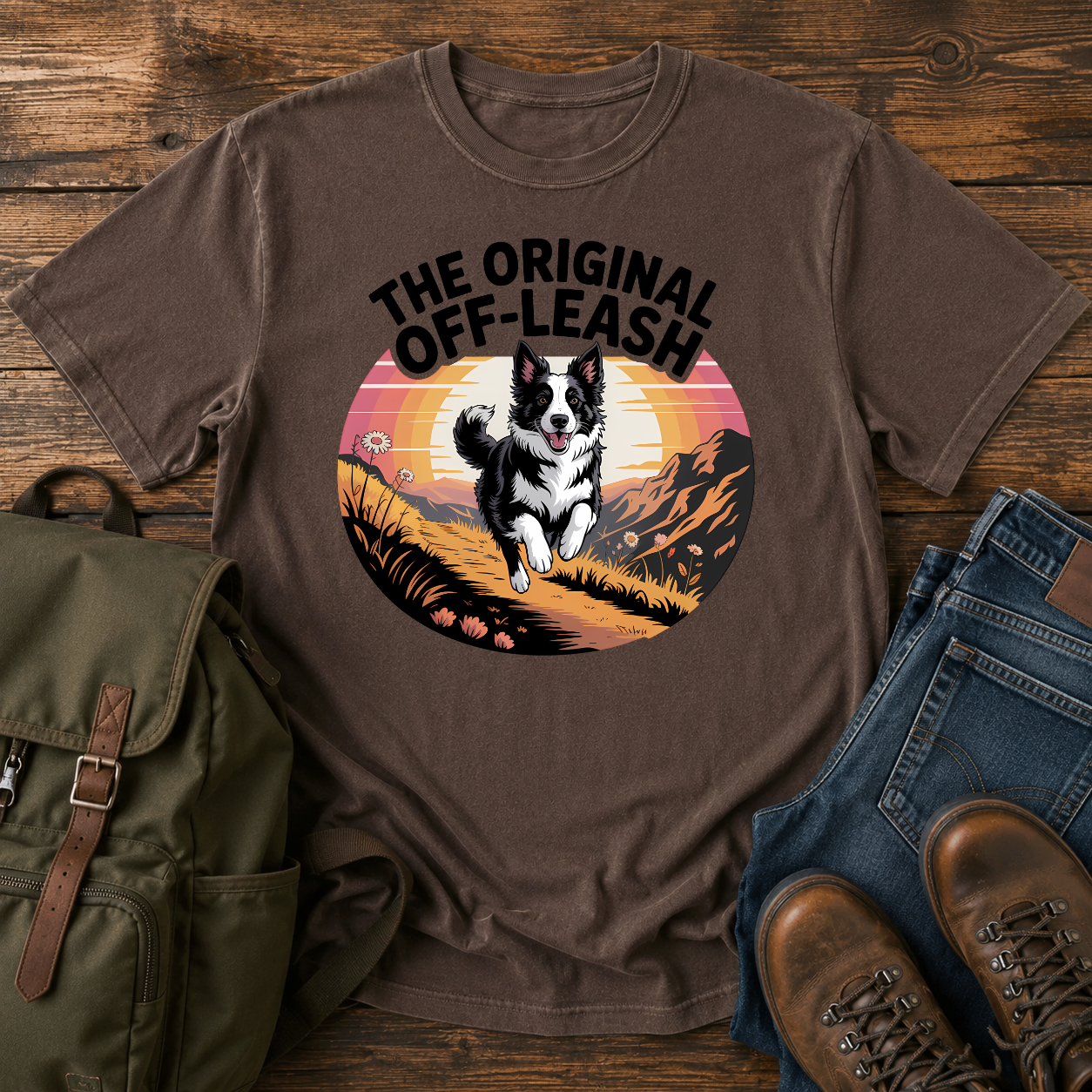 Border Collie running free along a mountain ridgeline at golden hour on a vintage-style adventure t-shirt.