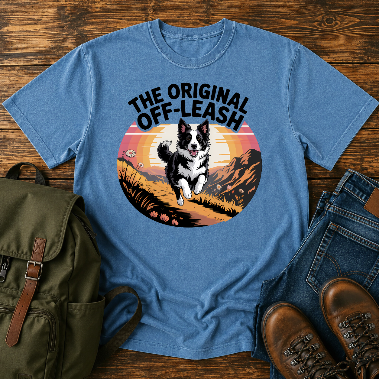 Border Collie running free along a mountain ridgeline at golden hour on a vintage-style adventure t-shirt.