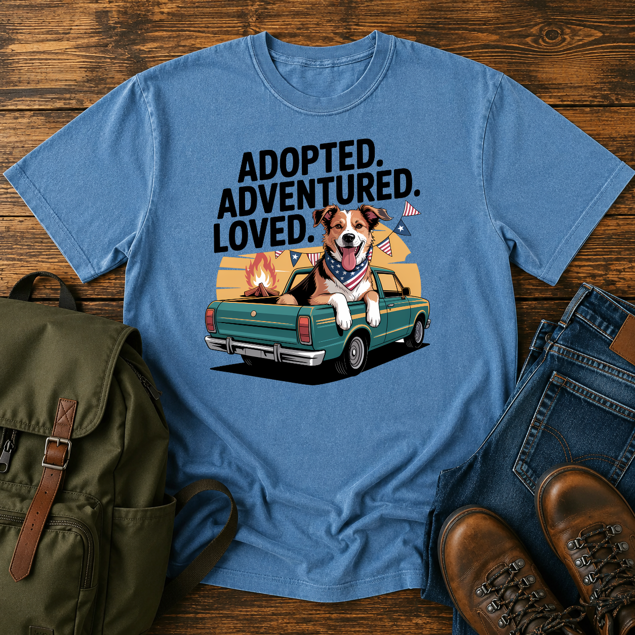 Patriotic rescue dog t-shirt showing a joyful mixed-breed dog with a red bandana at a campfire under an American flag.