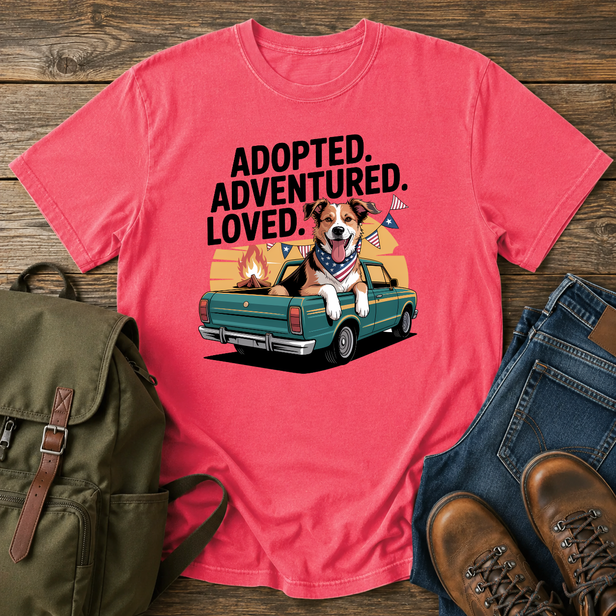 Patriotic rescue dog t-shirt showing a joyful mixed-breed dog with a red bandana at a campfire under an American flag.