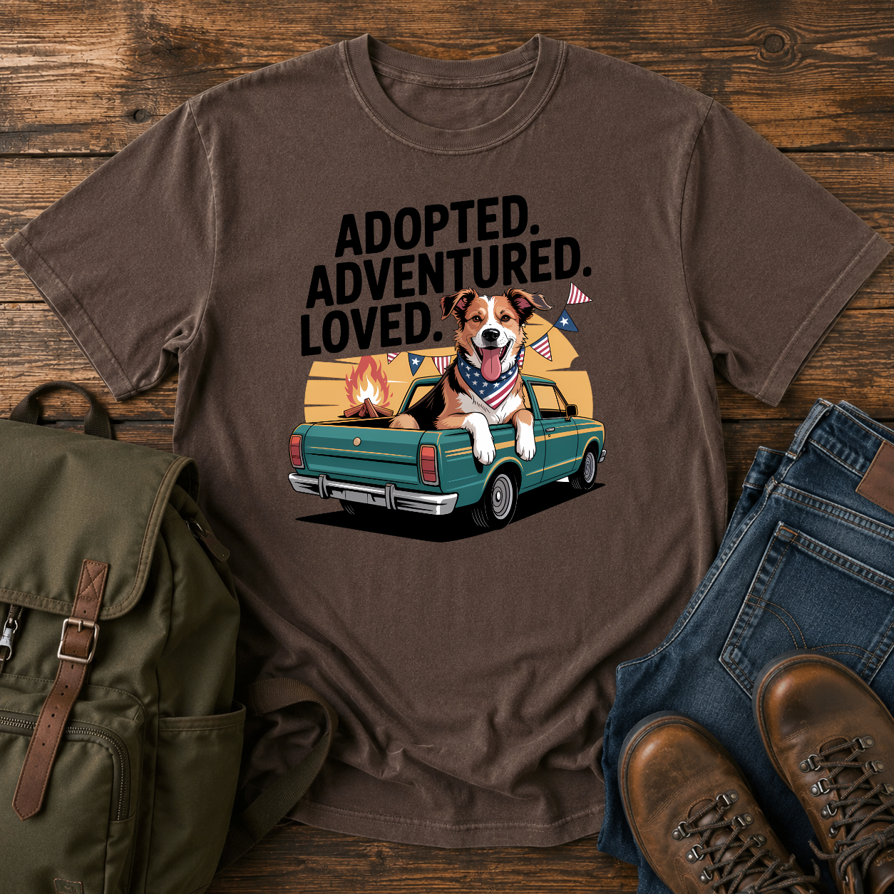 Patriotic rescue dog t-shirt showing a joyful mixed-breed dog with a red bandana at a campfire under an American flag.