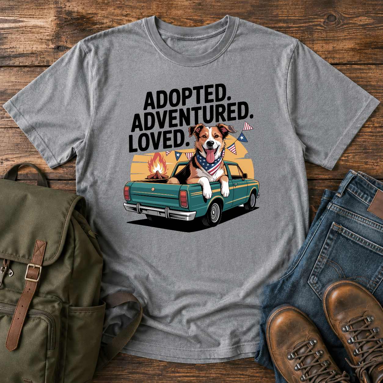 Patriotic rescue dog t-shirt showing a joyful mixed-breed dog with a red bandana at a campfire under an American flag.