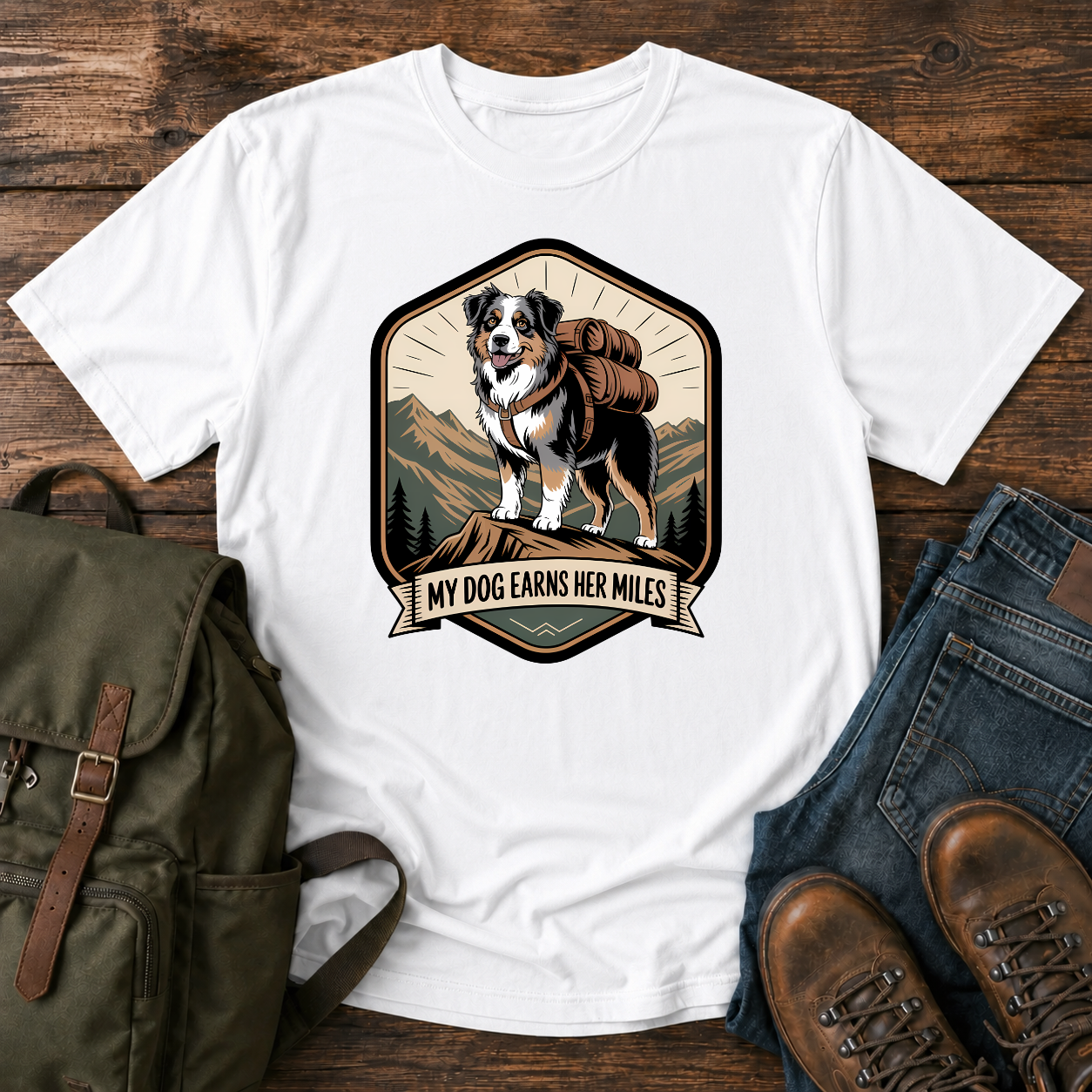 Retro trail-badge Australian Shepherd hiking shirt featuring an Aussie with a backpack on a mountain thru-hike trail.