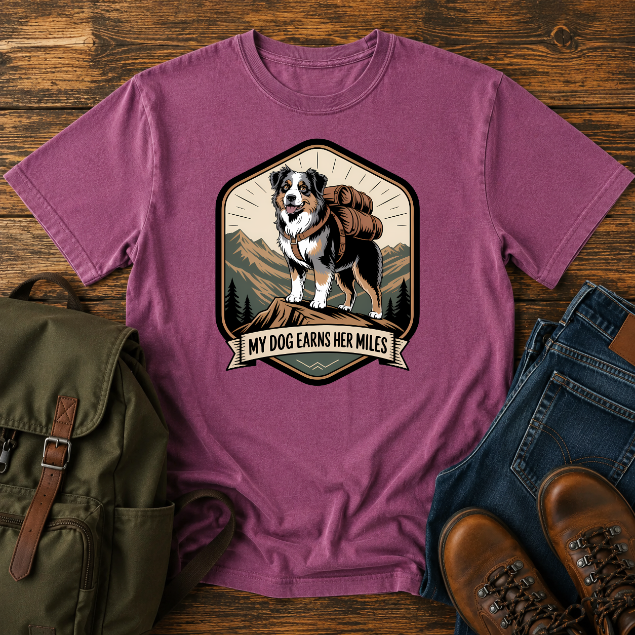 Retro trail-badge Australian Shepherd hiking shirt featuring an Aussie with a backpack on a mountain thru-hike trail.