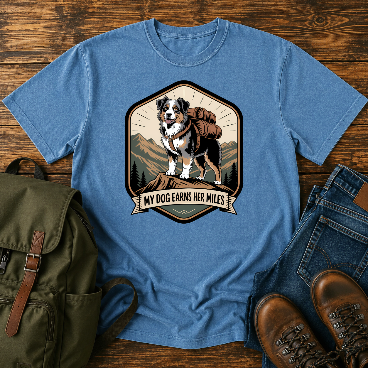Retro trail-badge Australian Shepherd hiking shirt featuring an Aussie with a backpack on a mountain thru-hike trail.