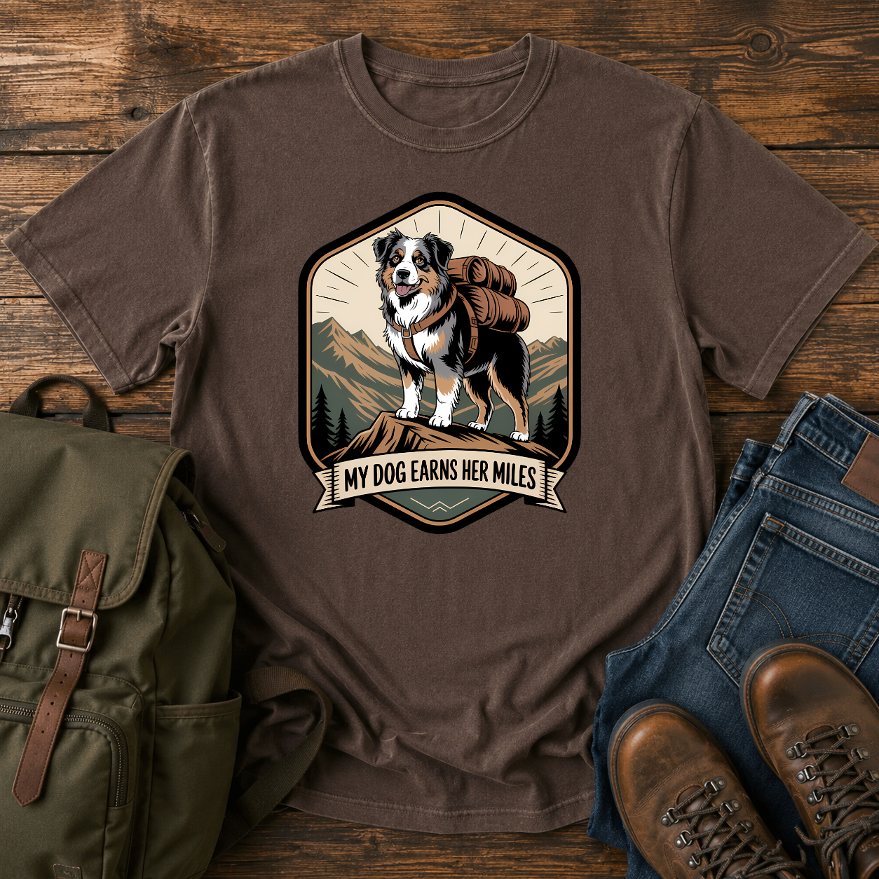 Retro trail-badge Australian Shepherd hiking shirt featuring an Aussie with a backpack on a mountain thru-hike trail.