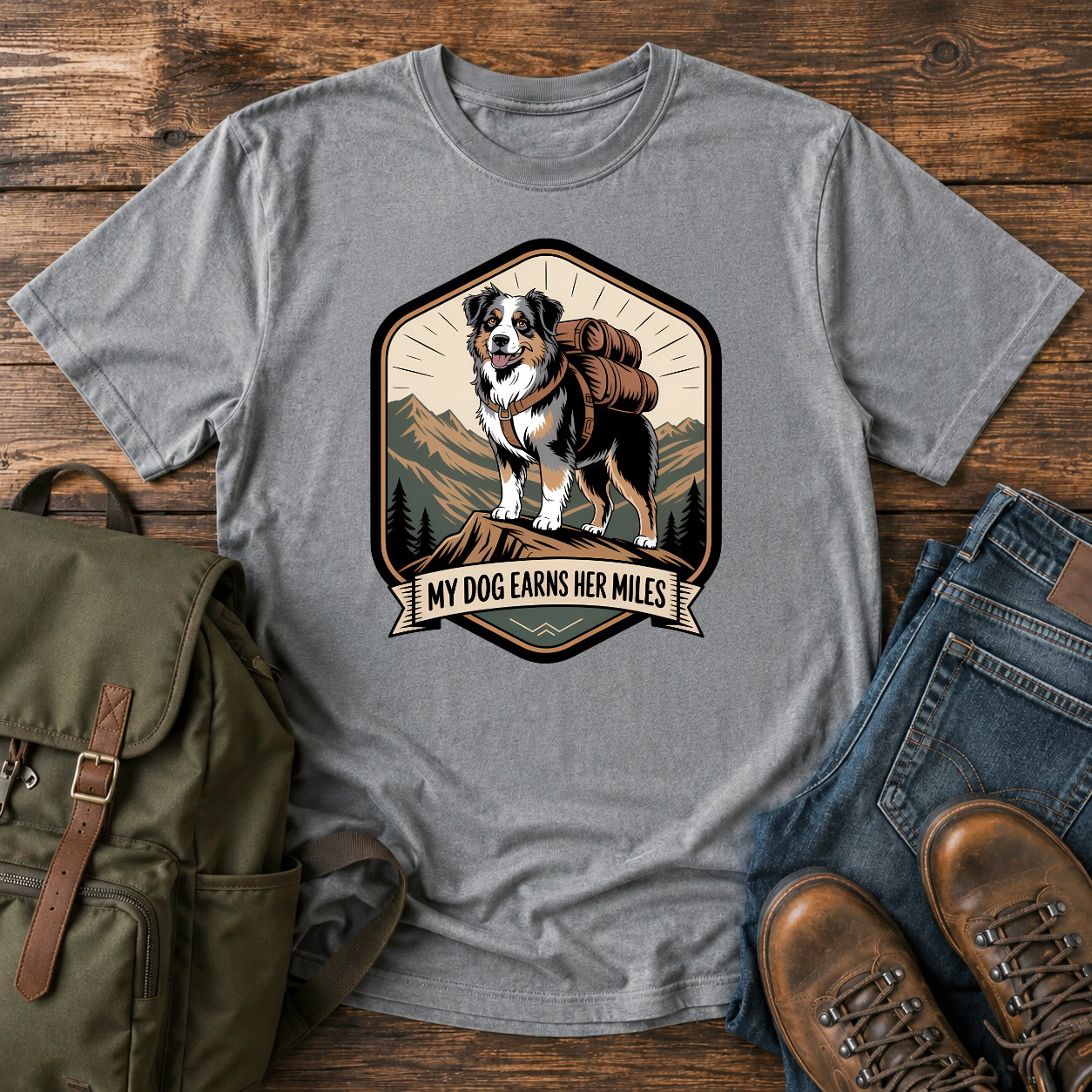 Retro trail-badge Australian Shepherd hiking shirt featuring an Aussie with a backpack on a mountain thru-hike trail.