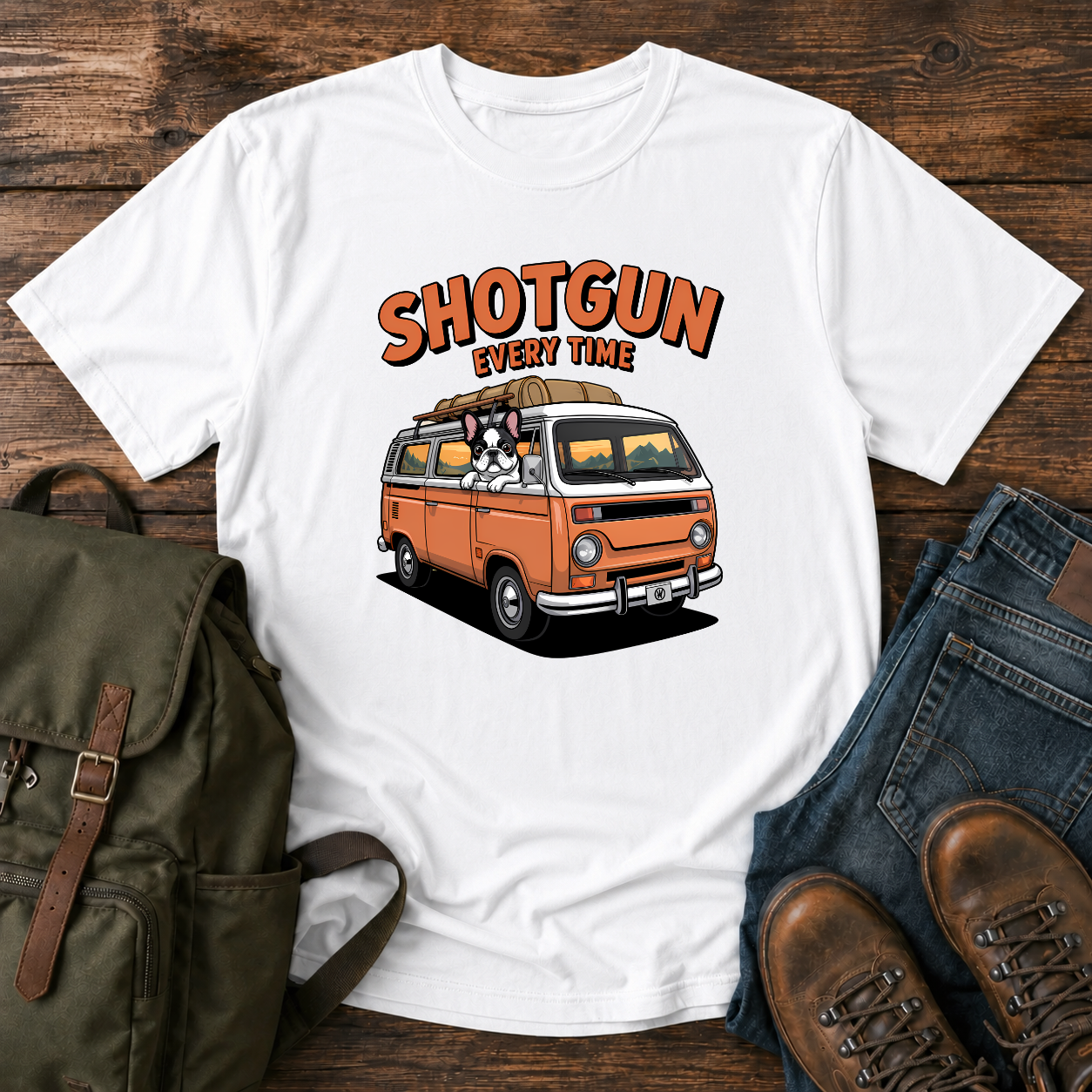 French Bulldog sitting shotgun in a retro camper van with mountain scenery on a vintage-style t-shirt.