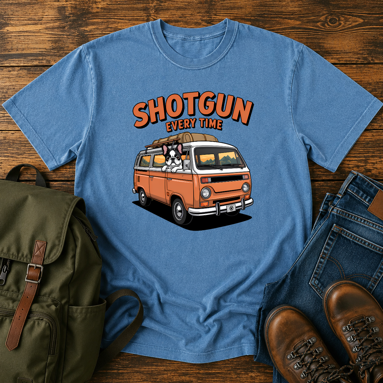 French Bulldog sitting shotgun in a retro camper van with mountain scenery on a vintage-style t-shirt.