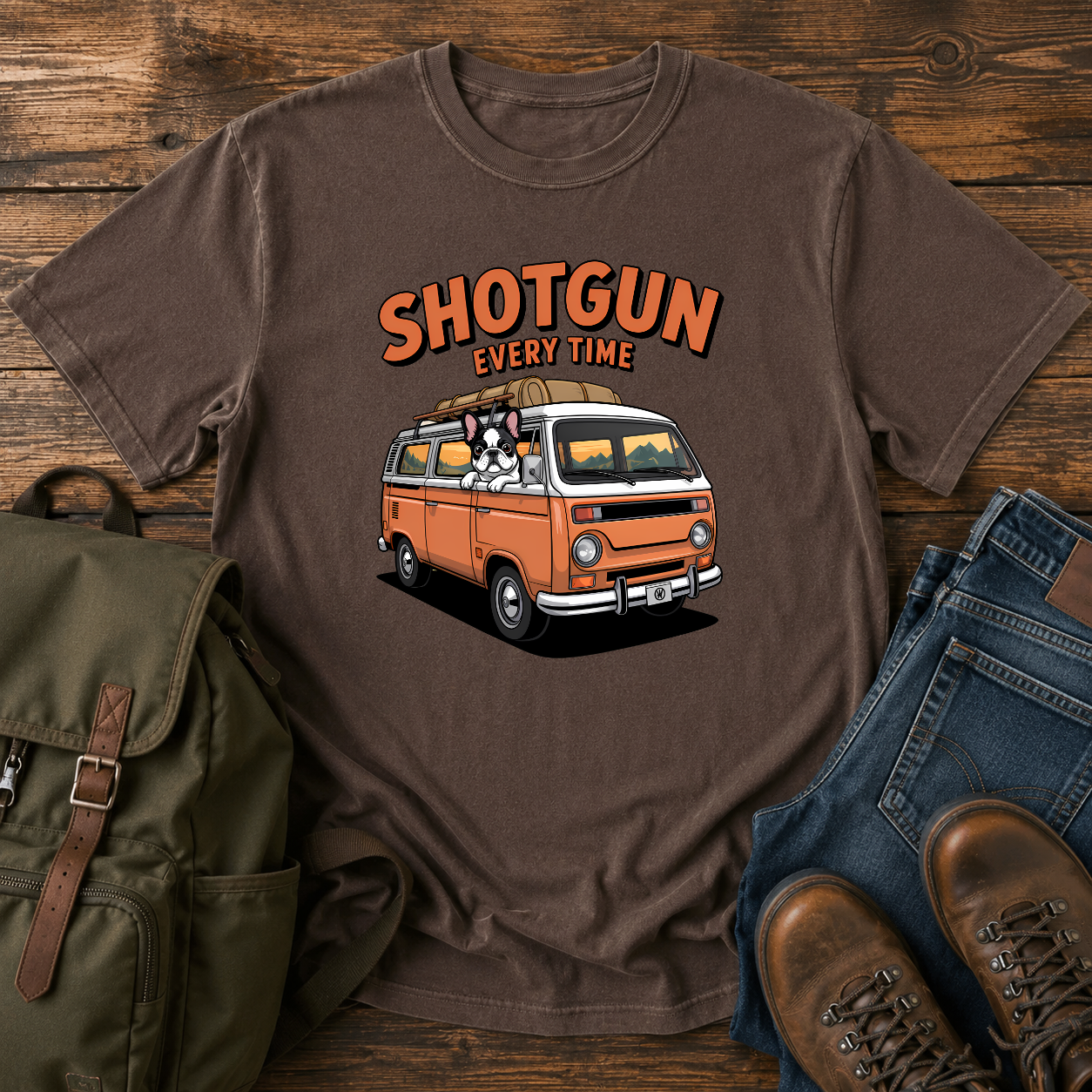 French Bulldog sitting shotgun in a retro camper van with mountain scenery on a vintage-style t-shirt.