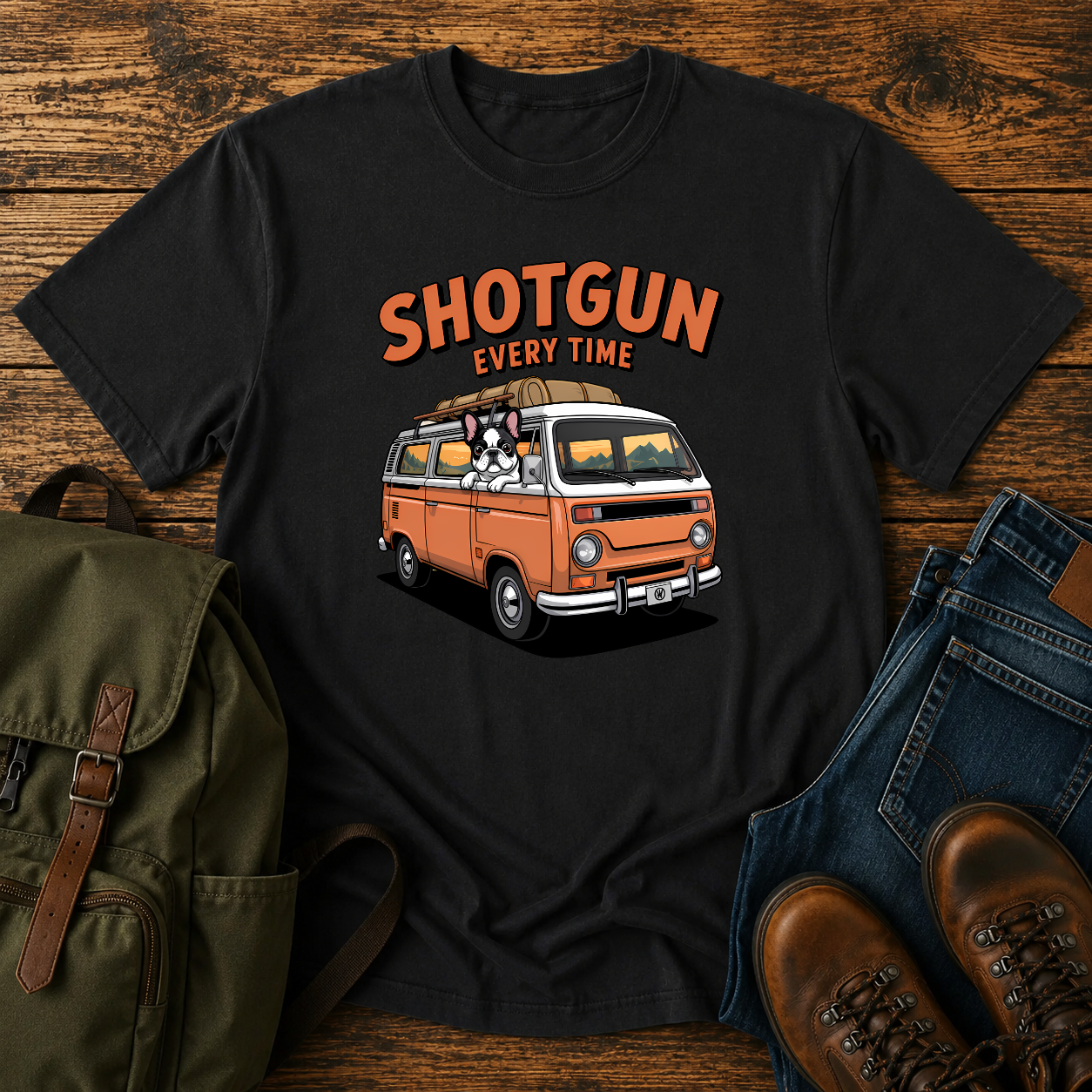 French Bulldog sitting shotgun in a retro camper van with mountain scenery on a vintage-style t-shirt.