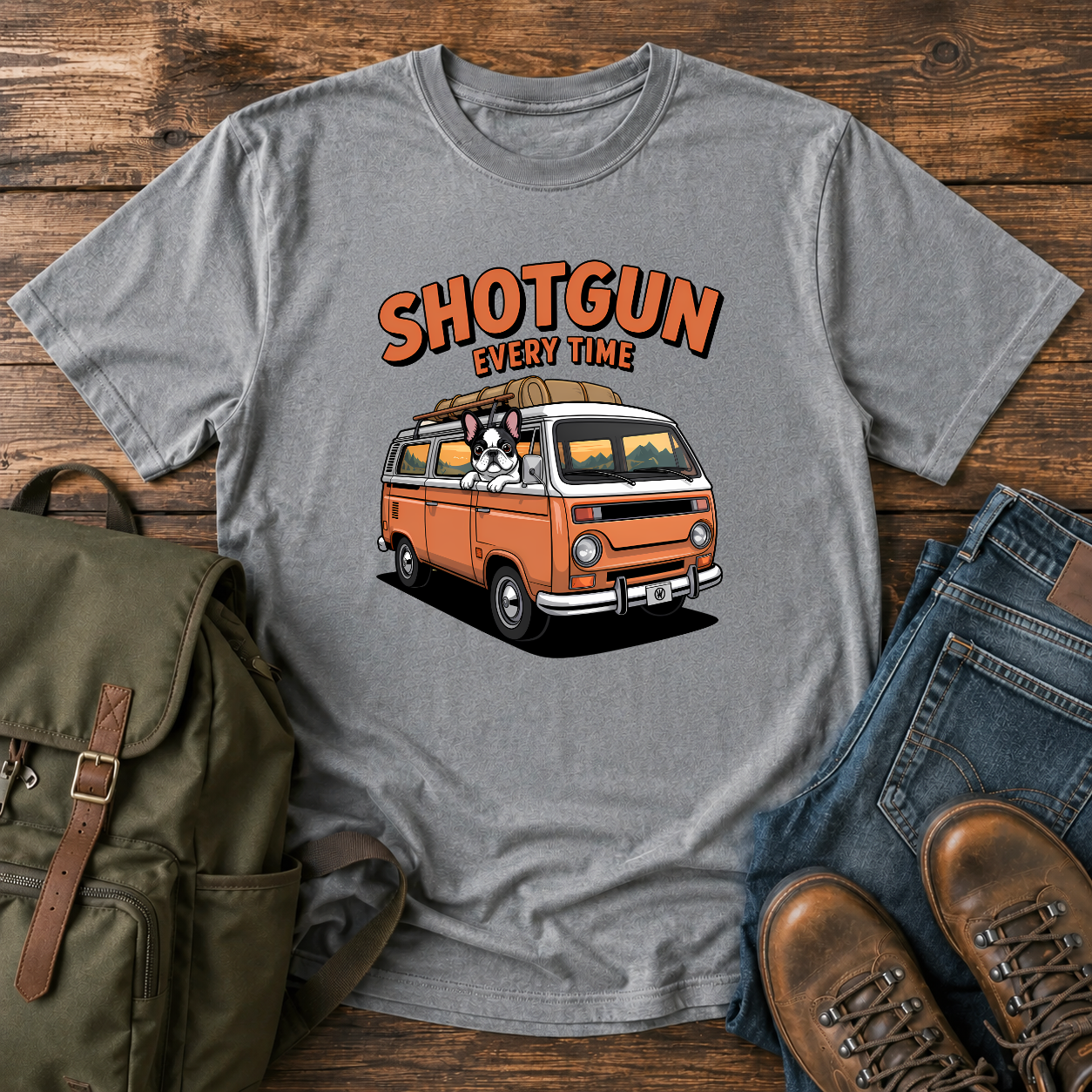 French Bulldog sitting shotgun in a retro camper van with mountain scenery on a vintage-style t-shirt.