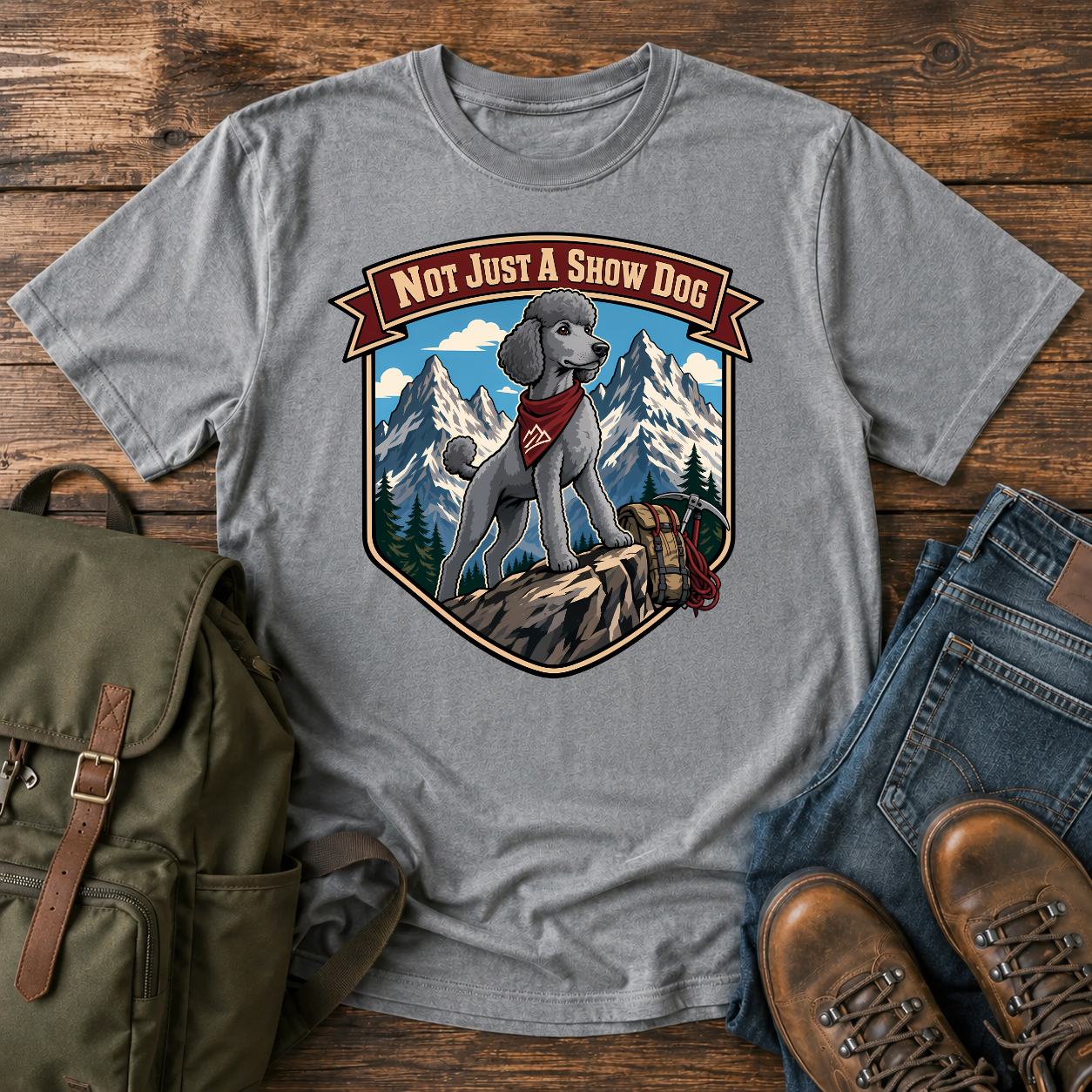 Standard Poodle in a sporty short clip cresting an alpine ridge wearing a bandana t-shirt design
