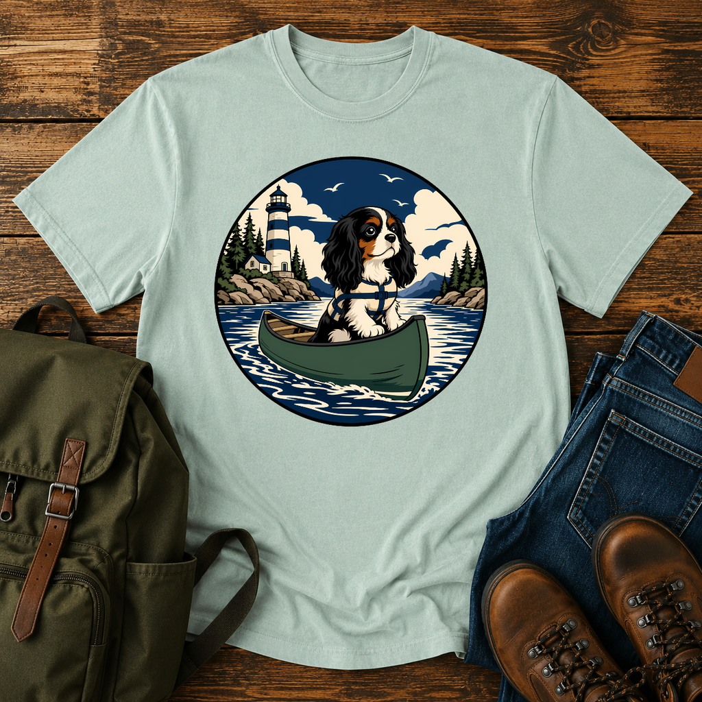 Cavalier King Charles Spaniel wearing a tiny life jacket sitting at the bow of a green t-shirt design