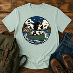 Cavalier King Charles Spaniel wearing a tiny life jacket sitting at the bow of a green t-shirt design