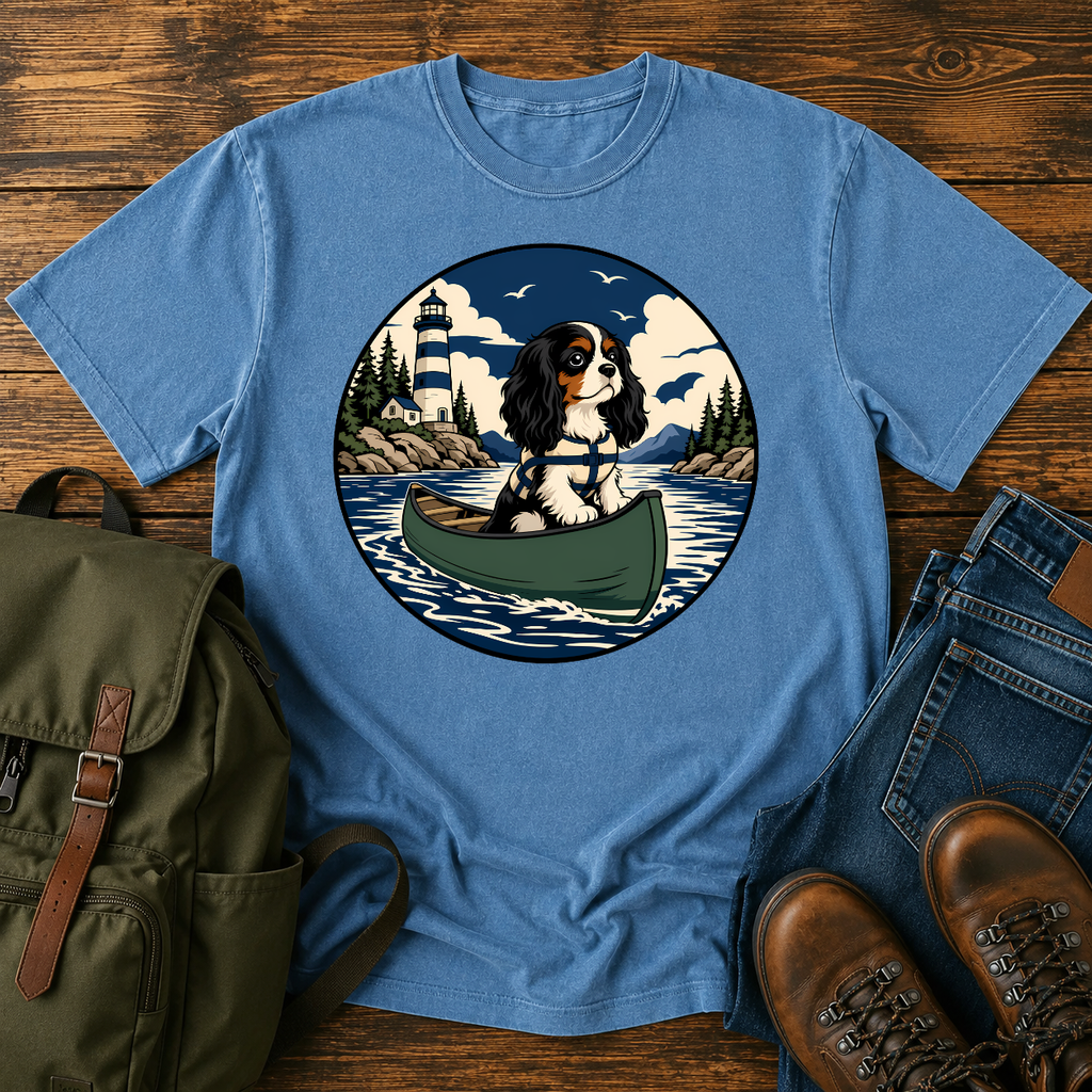Cavalier King Charles Spaniel wearing a tiny life jacket sitting at the bow of a green t-shirt design