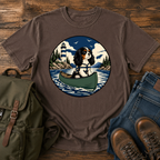 Cavalier King Charles Spaniel wearing a tiny life jacket sitting at the bow of a green t-shirt design