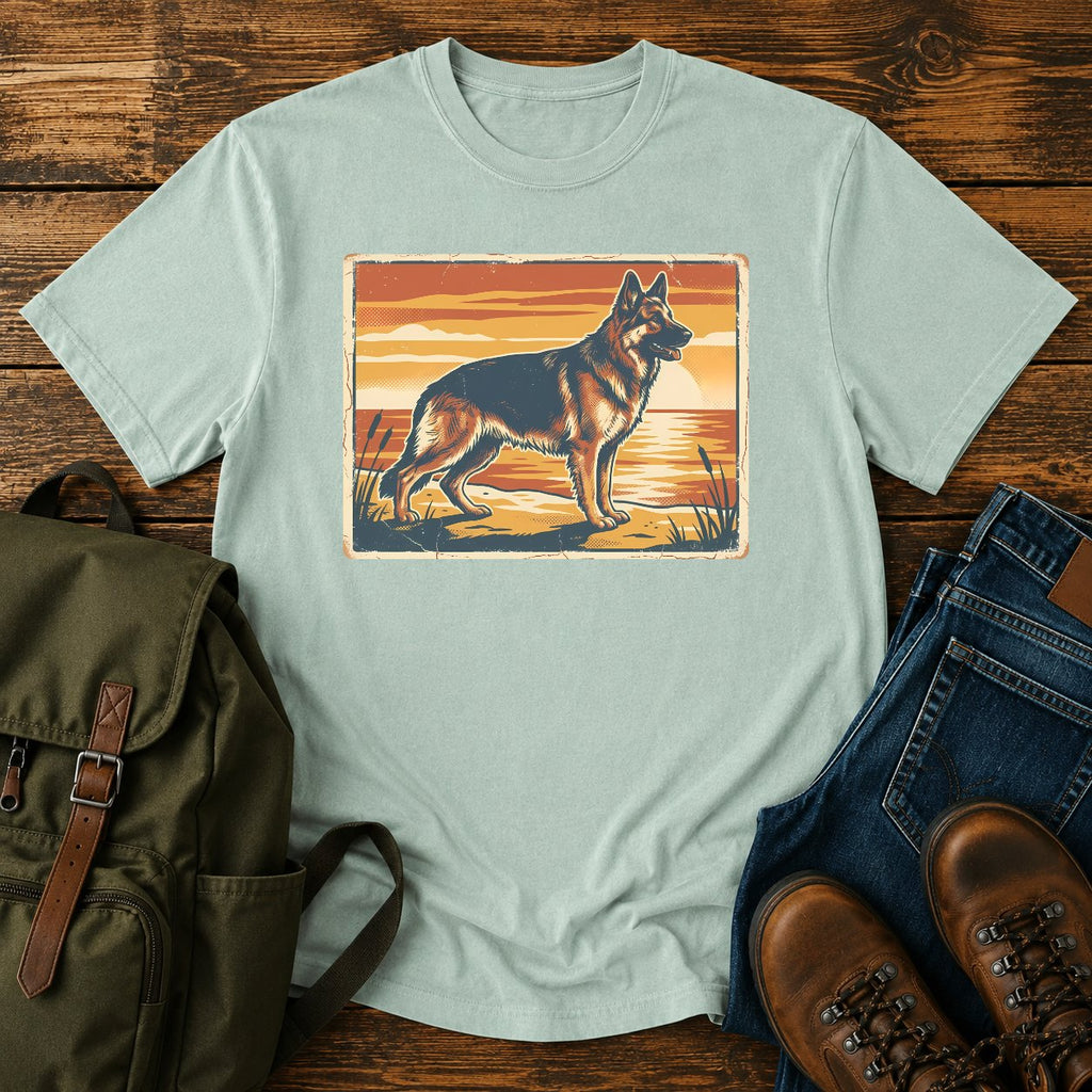 German Shepherd lake sunset t-shirt design with dog standing at the waterline.